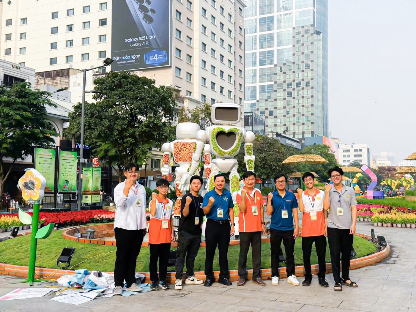 The project team and faculty posing in front of the two robots